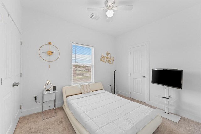 bedroom featuring light colored carpet and ceiling fan