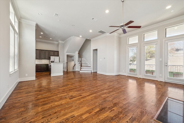 unfurnished living room with ceiling fan, dark wood-type flooring, and ornamental molding