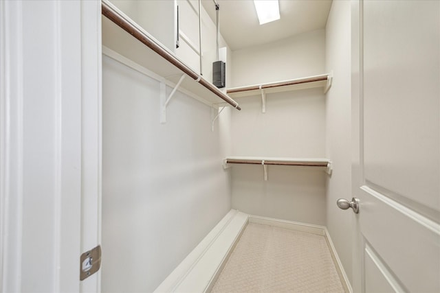 walk in closet featuring a skylight