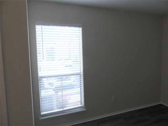 empty room with dark hardwood / wood-style floors