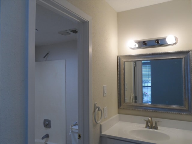 bathroom featuring shower / bathing tub combination and vanity