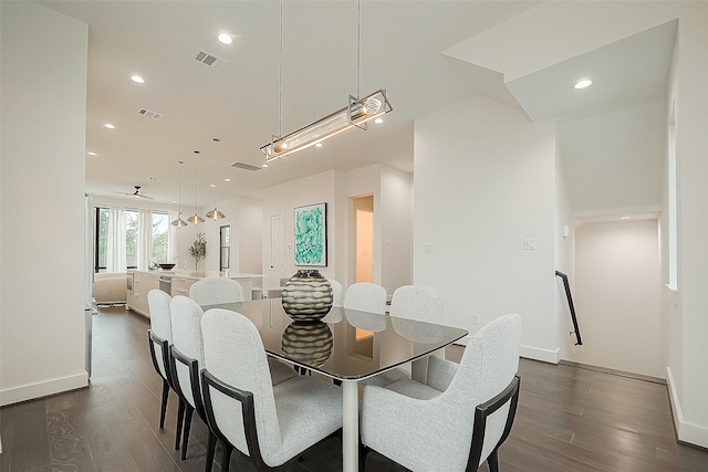 dining area featuring ceiling fan and dark hardwood / wood-style flooring