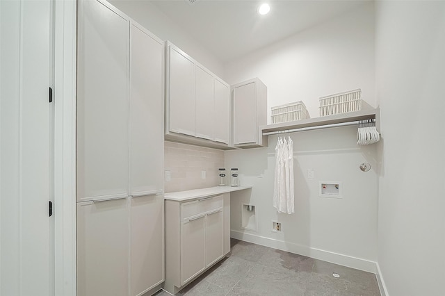 clothes washing area with hookup for a washing machine and cabinets