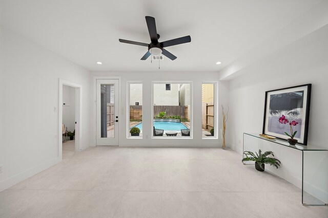 unfurnished living room with ceiling fan