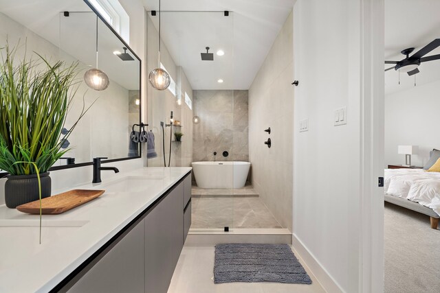 bathroom with vanity, ceiling fan, and a bathing tub