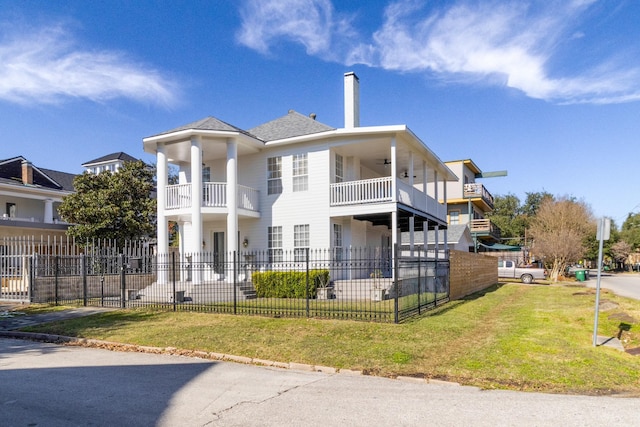 exterior space with a balcony and a yard