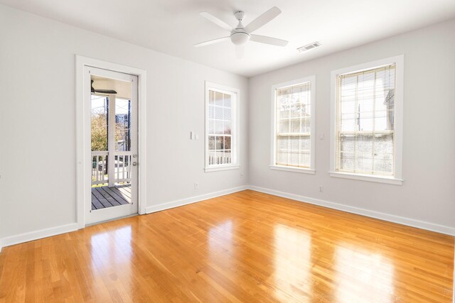 empty room with hardwood / wood-style flooring and ceiling fan