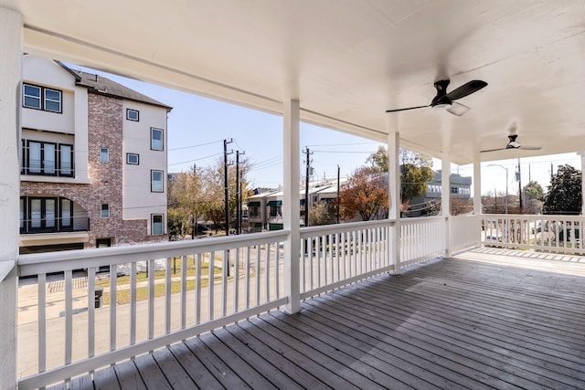 wooden deck featuring ceiling fan