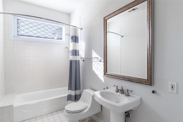 full bathroom featuring sink, tile patterned floors, toilet, and shower / bath combo