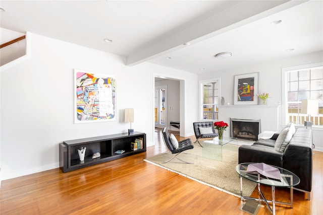 living room featuring recessed lighting, a fireplace, wood finished floors, baseboards, and beam ceiling