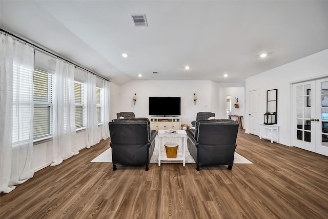 living room with french doors, dark hardwood / wood-style floors, and vaulted ceiling