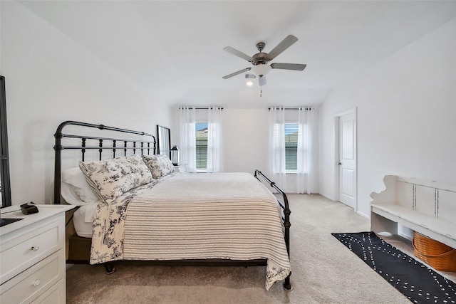 bedroom with ceiling fan, light colored carpet, and lofted ceiling