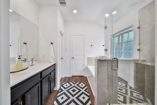 bathroom featuring separate shower and tub, vanity, and wood-type flooring