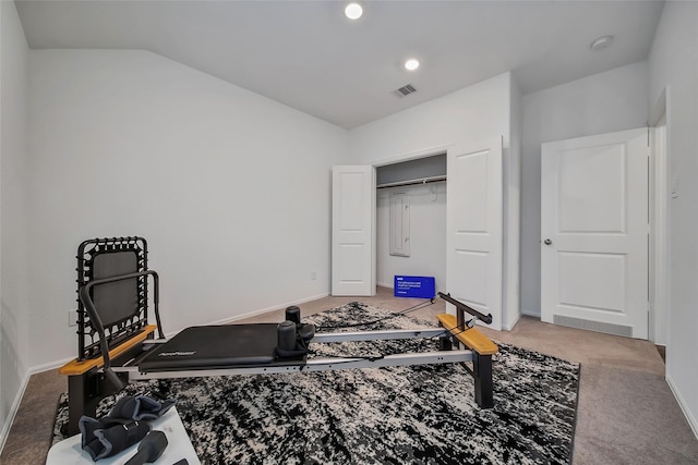 exercise room featuring carpet floors and vaulted ceiling