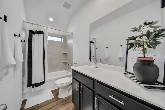 full bathroom featuring shower / tub combo, vanity, wood-type flooring, toilet, and lofted ceiling