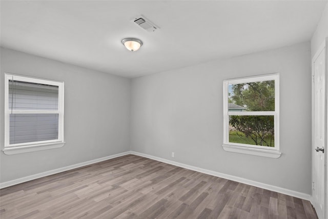 unfurnished room with light wood-type flooring