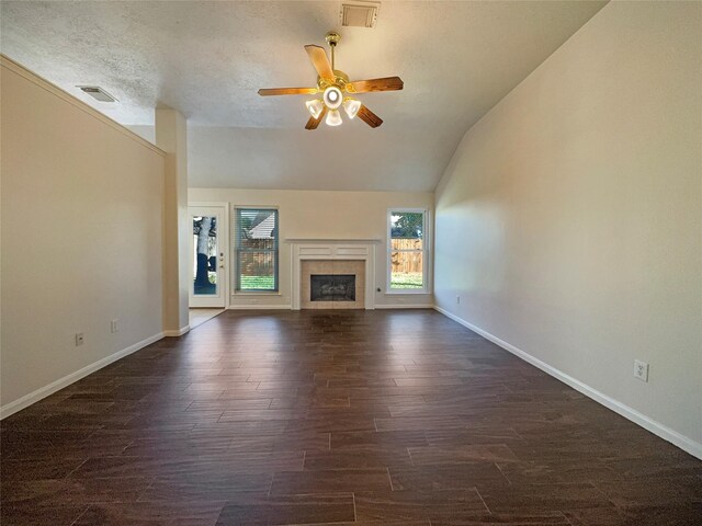 unfurnished living room featuring a textured ceiling, ceiling fan, a fireplace, dark hardwood / wood-style floors, and lofted ceiling