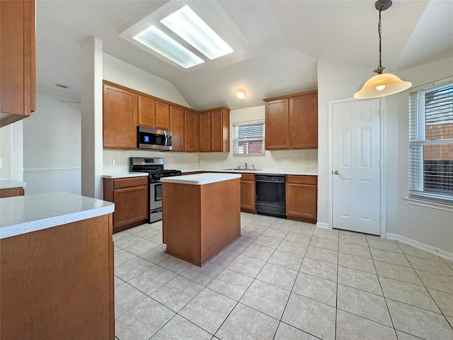 kitchen featuring sink, lofted ceiling, decorative light fixtures, a kitchen island, and appliances with stainless steel finishes