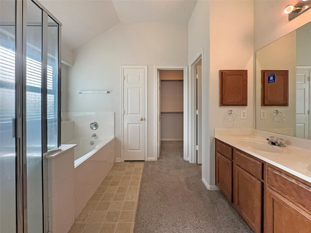 bathroom with vanity, lofted ceiling, and shower with separate bathtub