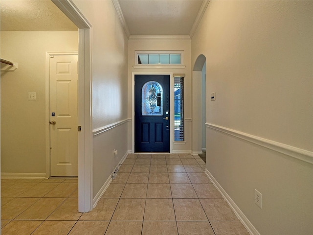 foyer with a textured ceiling, crown molding, and light tile patterned flooring