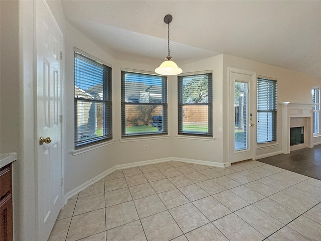 unfurnished dining area featuring light tile patterned flooring