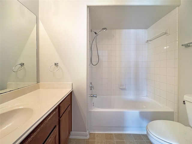 full bathroom featuring vanity, tiled shower / bath combo, and toilet