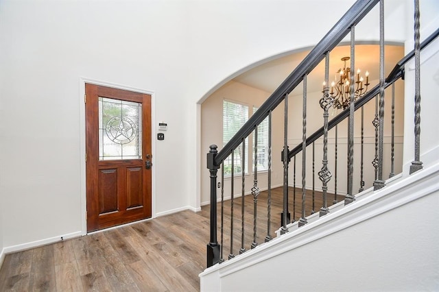 foyer featuring hardwood / wood-style floors, plenty of natural light, and a chandelier