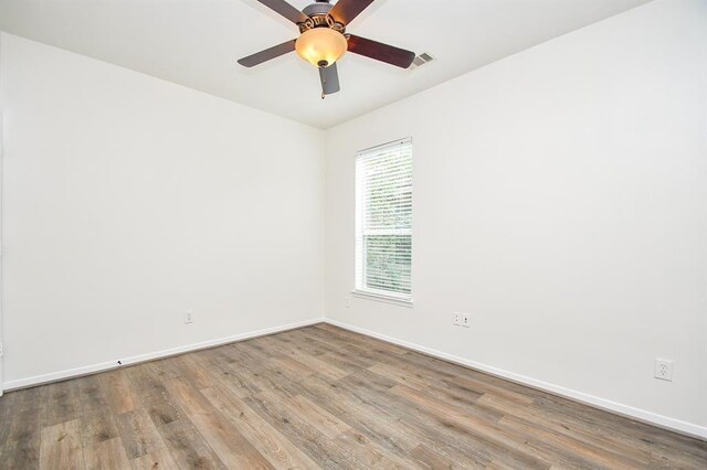 empty room featuring hardwood / wood-style floors and ceiling fan