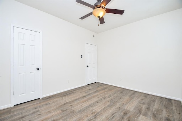 empty room with light hardwood / wood-style floors and ceiling fan