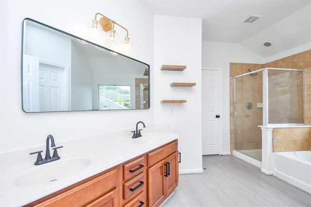 bathroom featuring shower with separate bathtub, vanity, and lofted ceiling