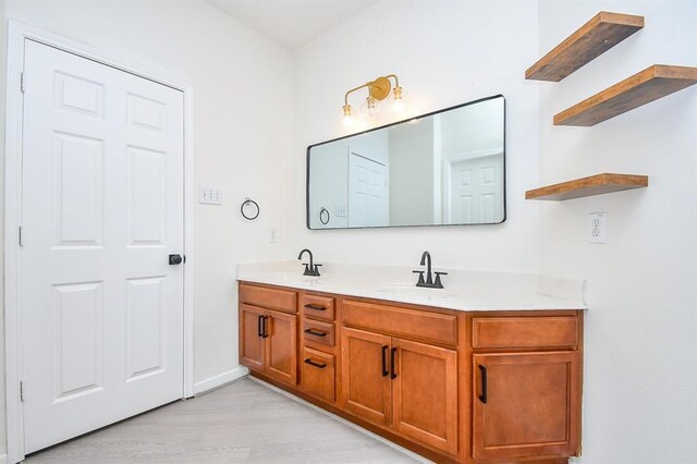 bathroom with hardwood / wood-style floors and vanity