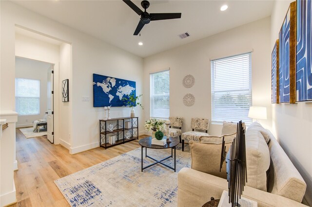 living room featuring light hardwood / wood-style floors, a wealth of natural light, and ceiling fan