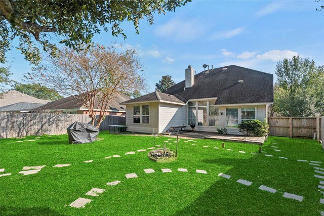 rear view of property featuring a lawn and a patio area