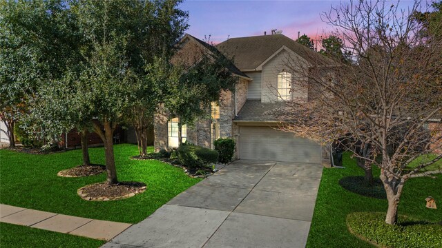 obstructed view of property featuring a garage and a yard