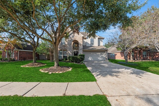 view of front facade with a front yard and a garage