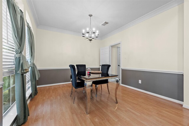 office space featuring ornamental molding, light hardwood / wood-style floors, and an inviting chandelier