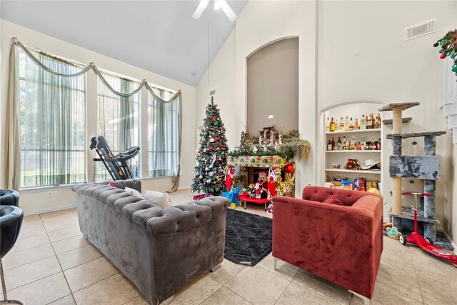 living room with ceiling fan, light tile patterned floors, and high vaulted ceiling