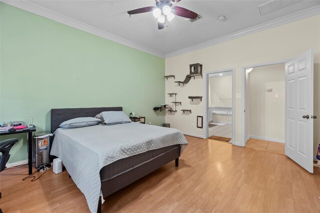 bedroom featuring ceiling fan, ensuite bathroom, crown molding, and light hardwood / wood-style flooring