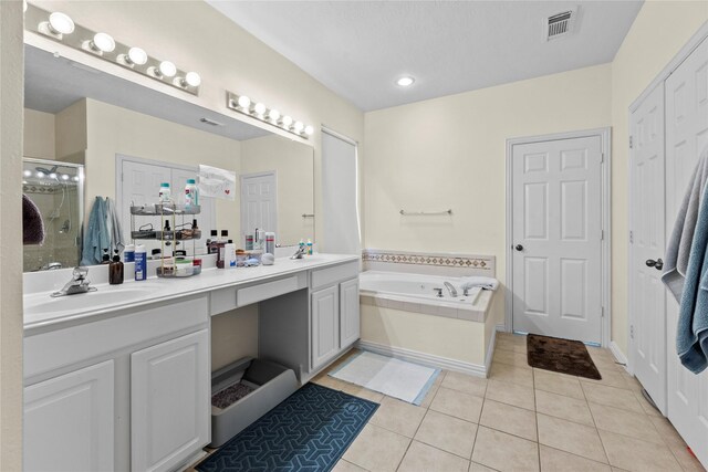 bathroom featuring tile patterned flooring, vanity, and separate shower and tub