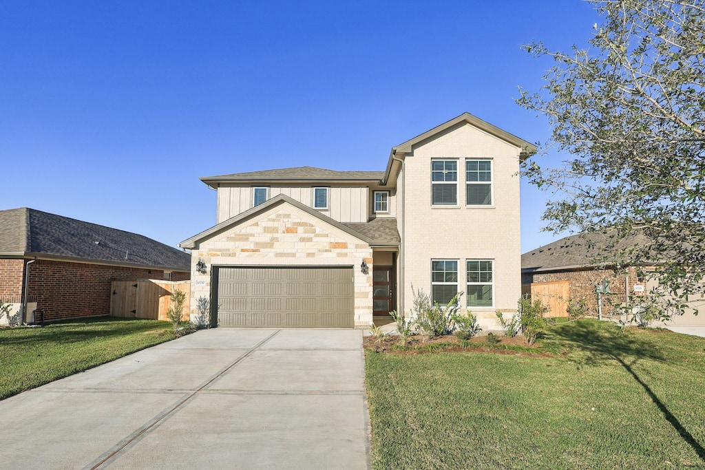 view of front property featuring a garage and a front yard