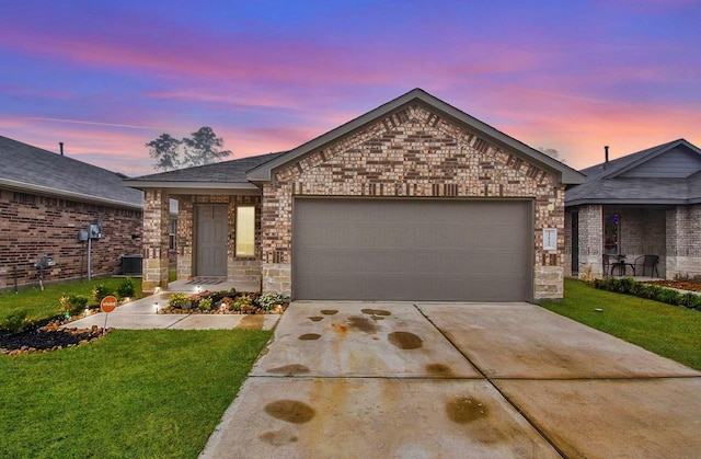 view of front of house featuring a yard and a garage