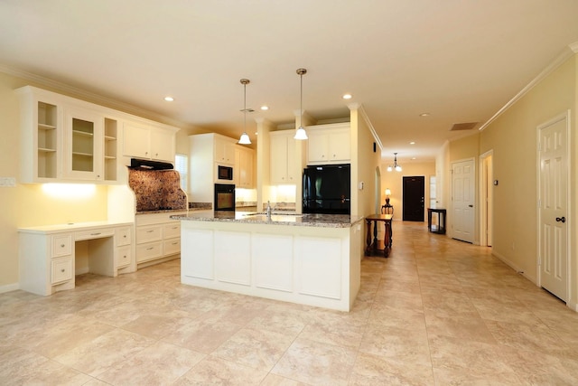 kitchen with black appliances, white cabinets, light stone countertops, an island with sink, and decorative light fixtures