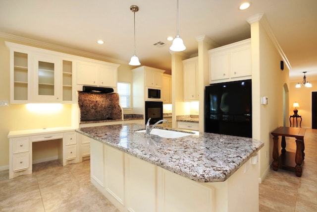 kitchen featuring white cabinets, sink, a large island, and black appliances