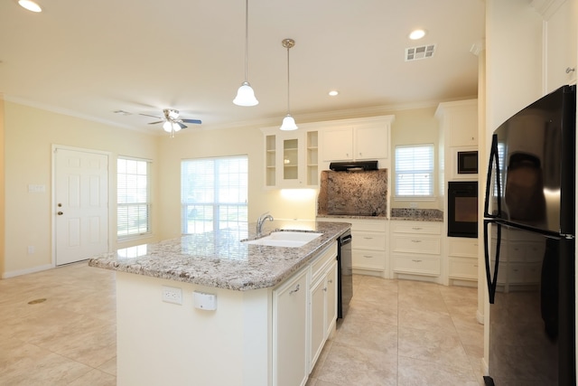 kitchen with black appliances, a center island with sink, sink, tasteful backsplash, and white cabinetry