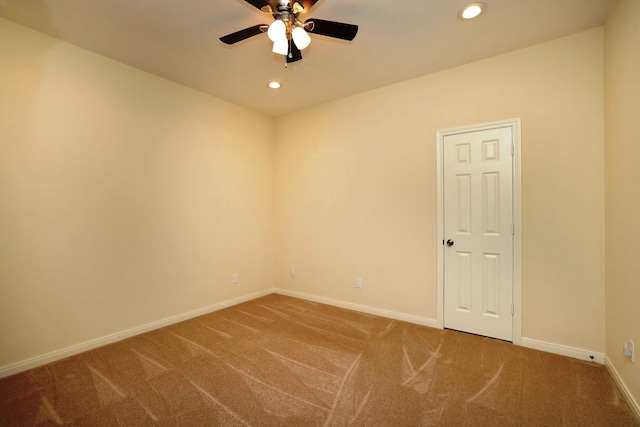 spare room featuring carpet flooring and ceiling fan