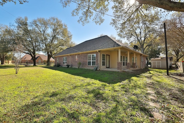 view of side of property with a yard and a storage shed