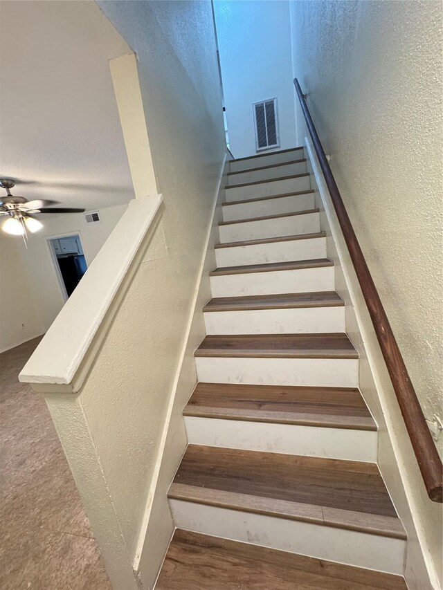 stairway with ceiling fan