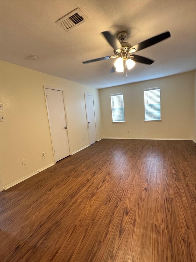 unfurnished room with dark hardwood / wood-style floors and ceiling fan