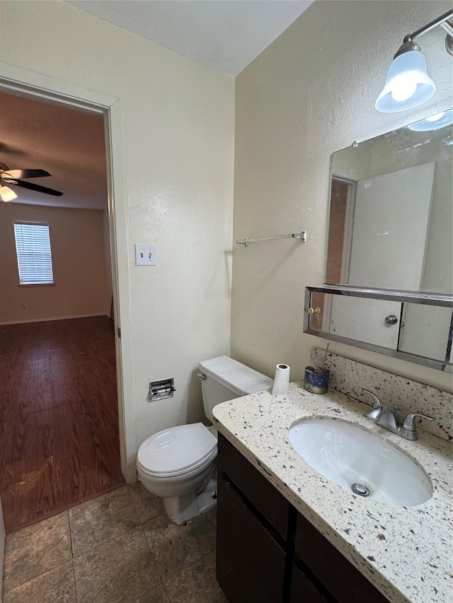 bathroom featuring vanity, ceiling fan, and toilet