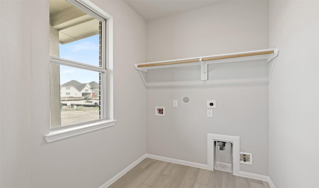 laundry area with hookup for a washing machine, electric dryer hookup, light wood finished floors, and laundry area